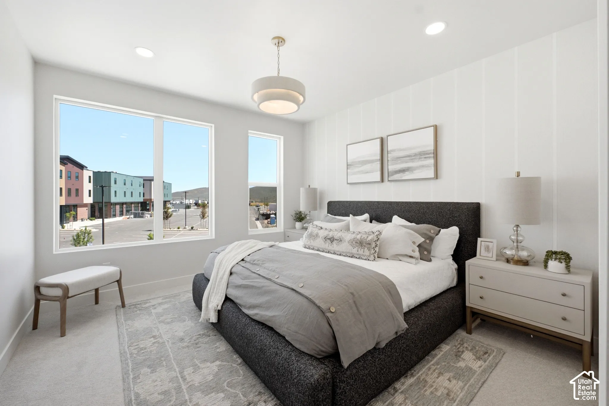 Bedroom featuring vertical shiplap accent wall, oversized windows, recessed lighting, and a modern tiered drum pendant light fixture