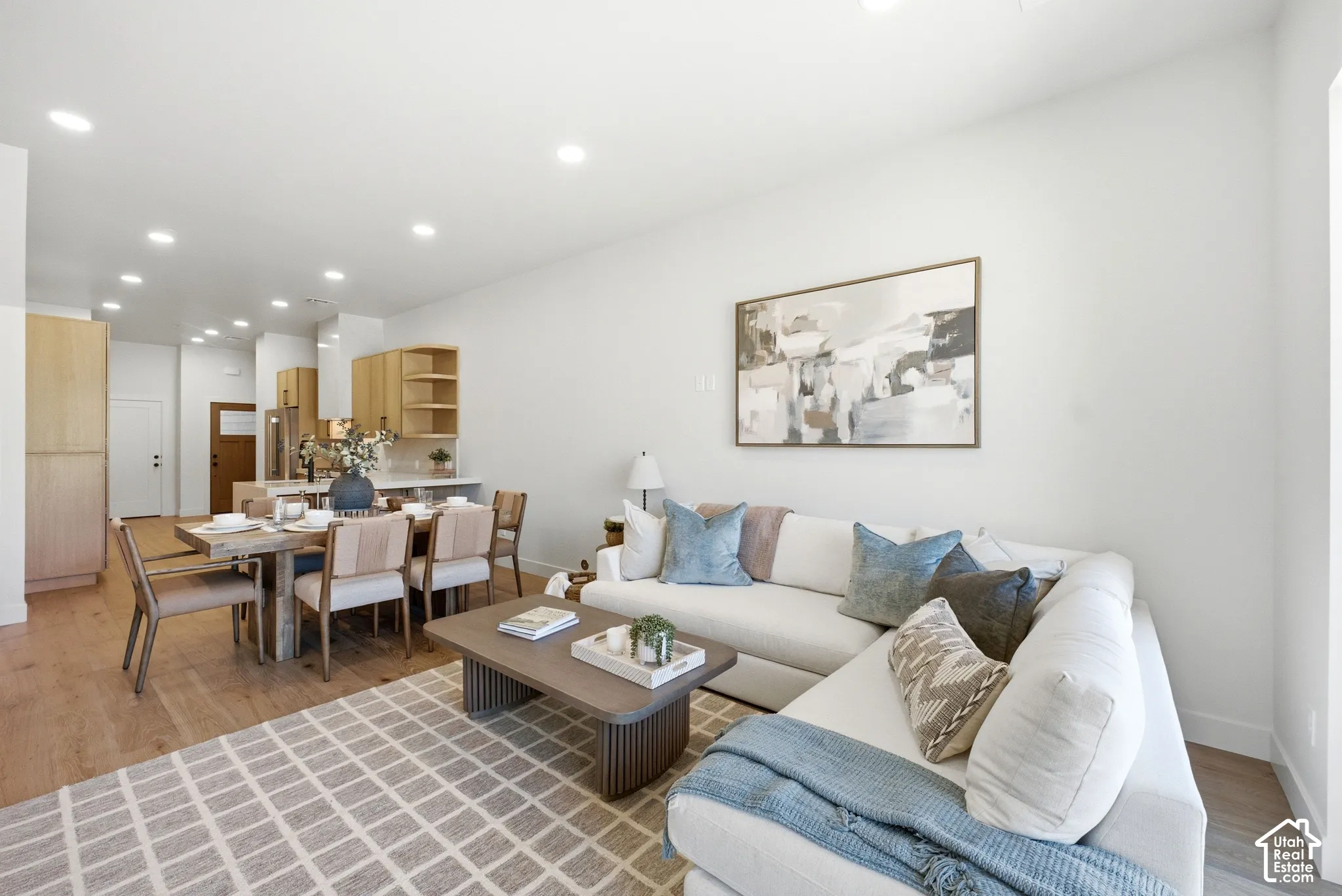 Open-concept interior featuring wood-finish flooring, recessed lighting, and flat-panel cabinetry
