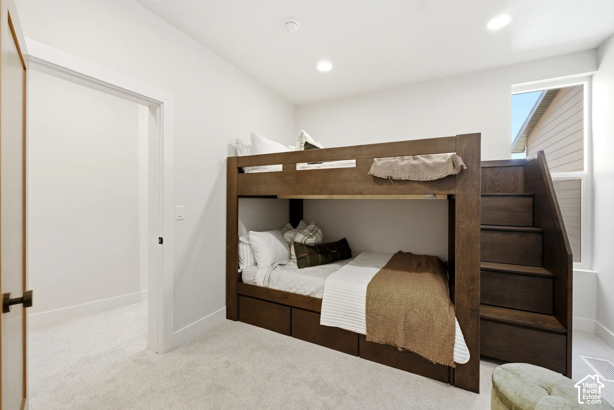 Room featuring neutral carpeting, recessed lighting, and a single-pane window