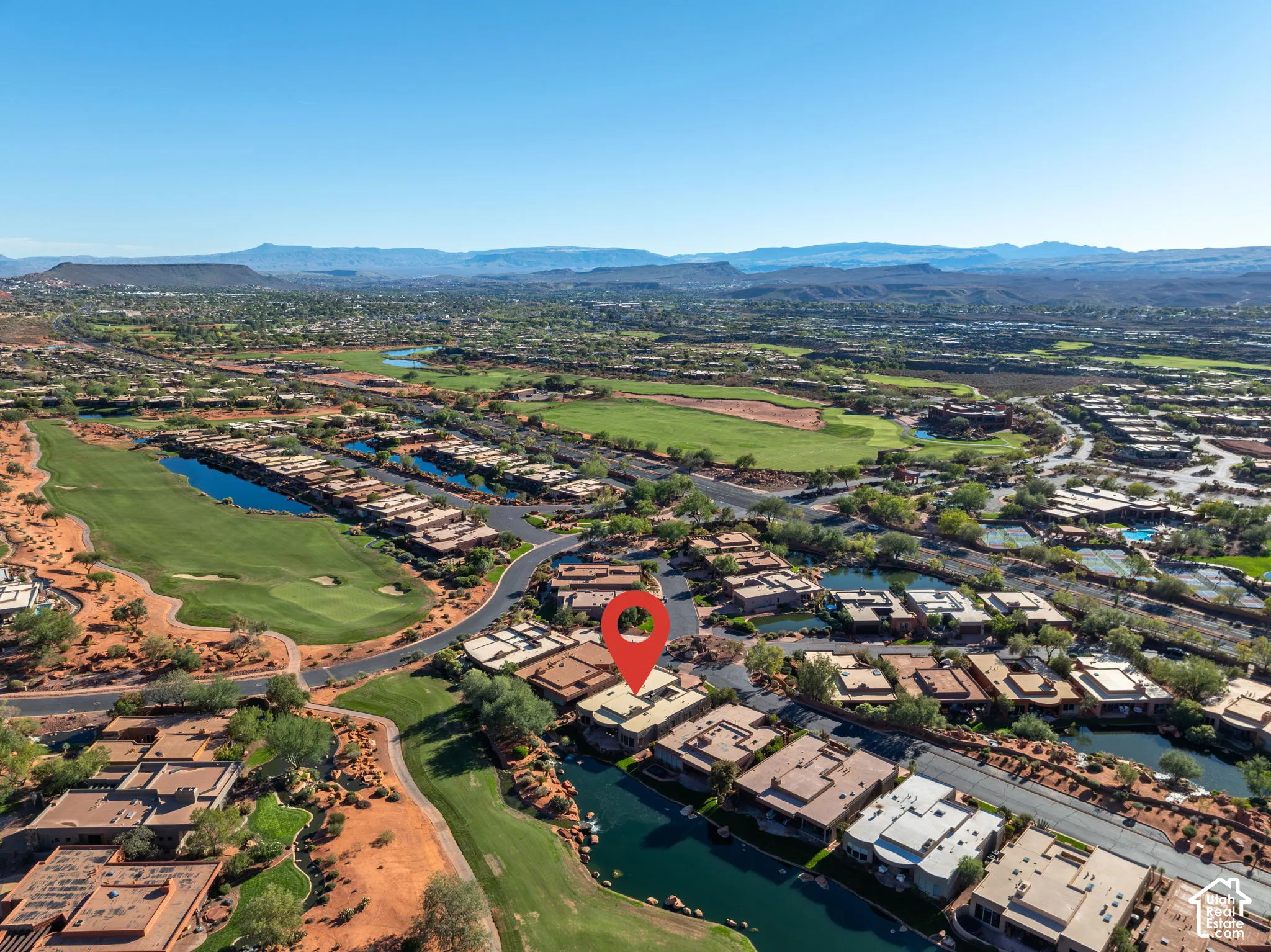 Aerial perspective featuring desert landscape, proximity to golf course greens, and direct water frontage