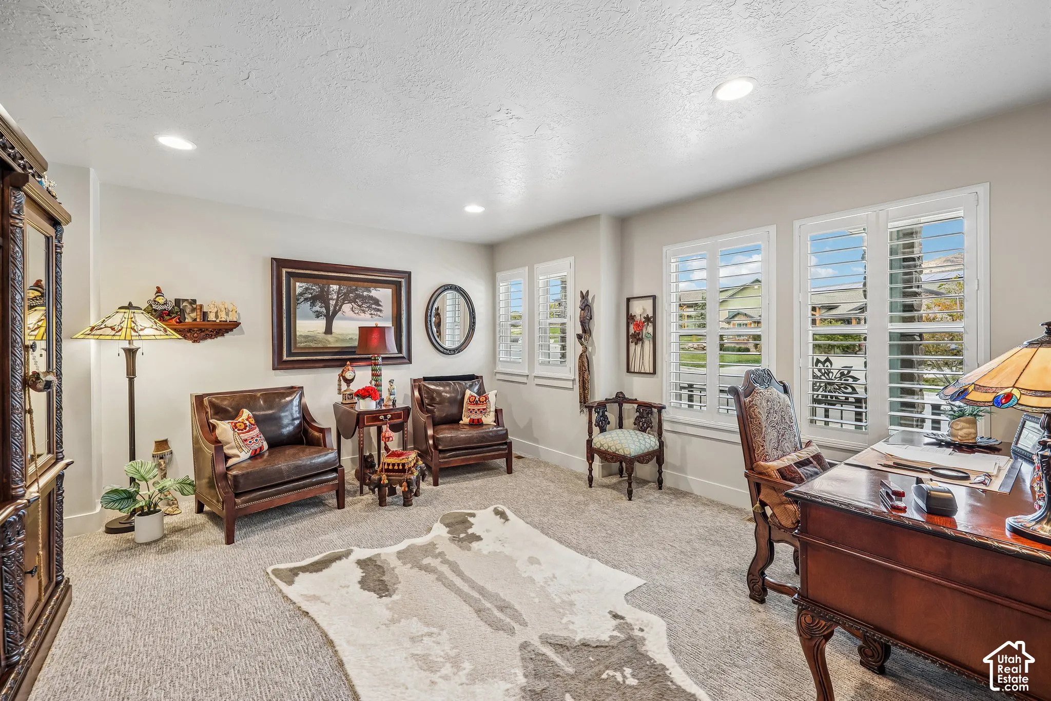 Room featuring recessed ceiling lighting, wall-to-wall carpeting, and custom white interior window shutters