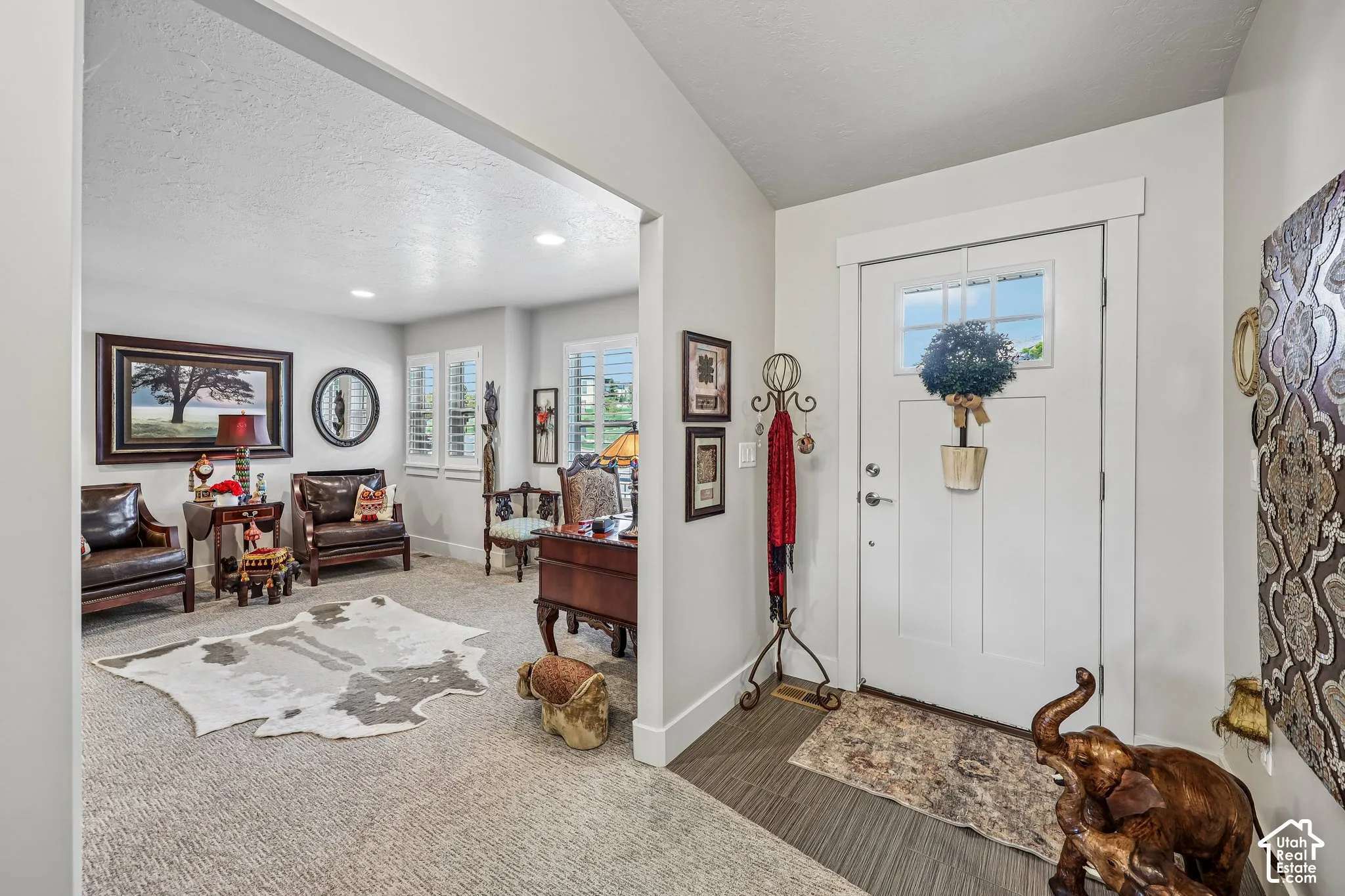 Entryway featuring a white door with a glass inlay, neutral carpeting, recessed ceiling lighting, and plantation shutters