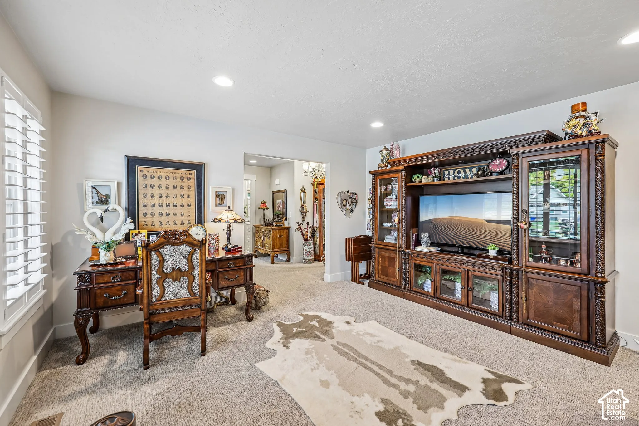 Living space featuring recessed lighting, carpeted flooring, and plantation shutters