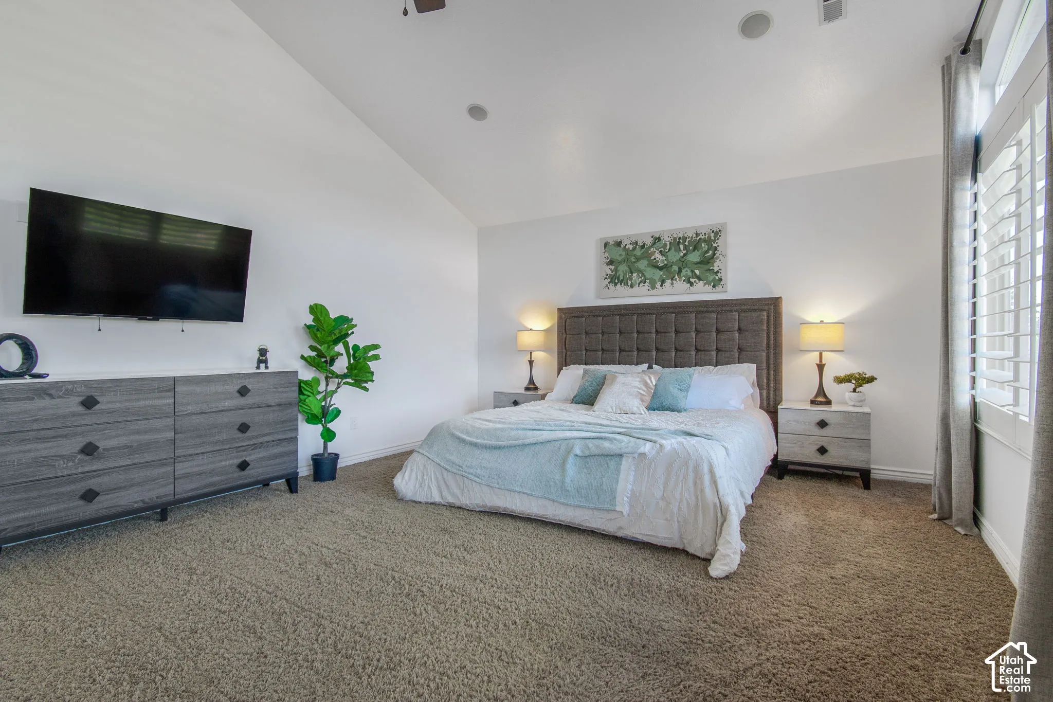 Vaulted ceiling, wall-to-wall carpeting, recessed lighting, and white plantation shutters