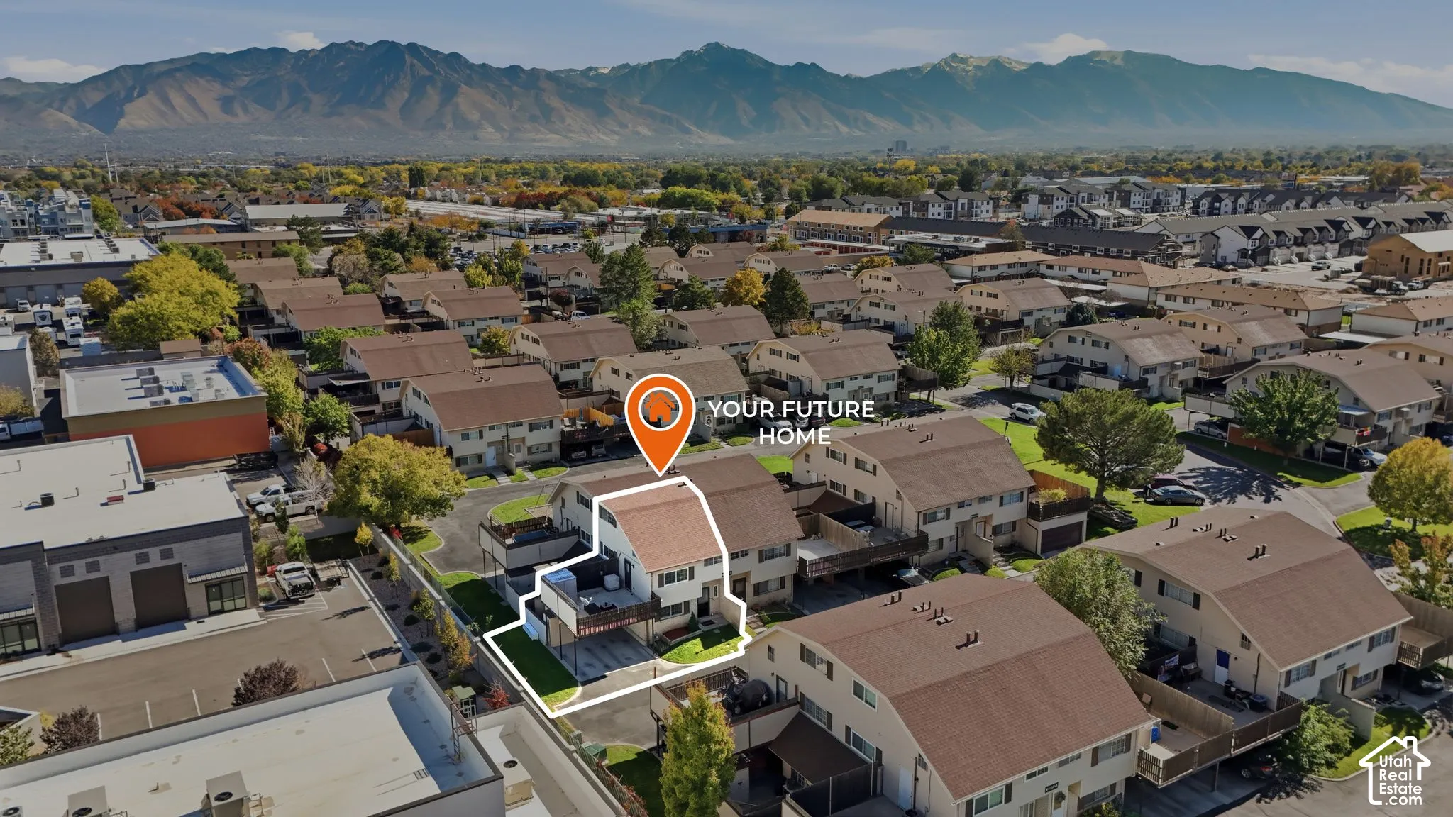Multi-level exterior featuring a shingled roof, attached balcony, private parking, and mountain backdrop