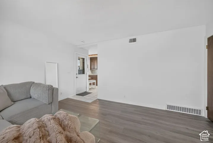 Interior space featuring wood-finish flooring and a white exterior door with glass pane inset