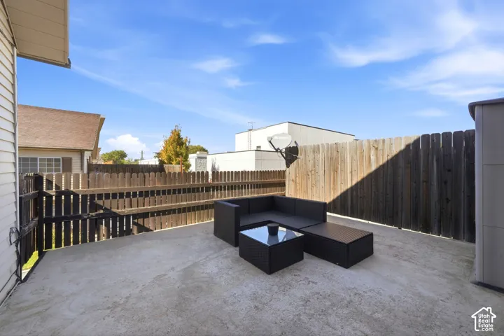 Deck area enclosed by a wood privacy fence