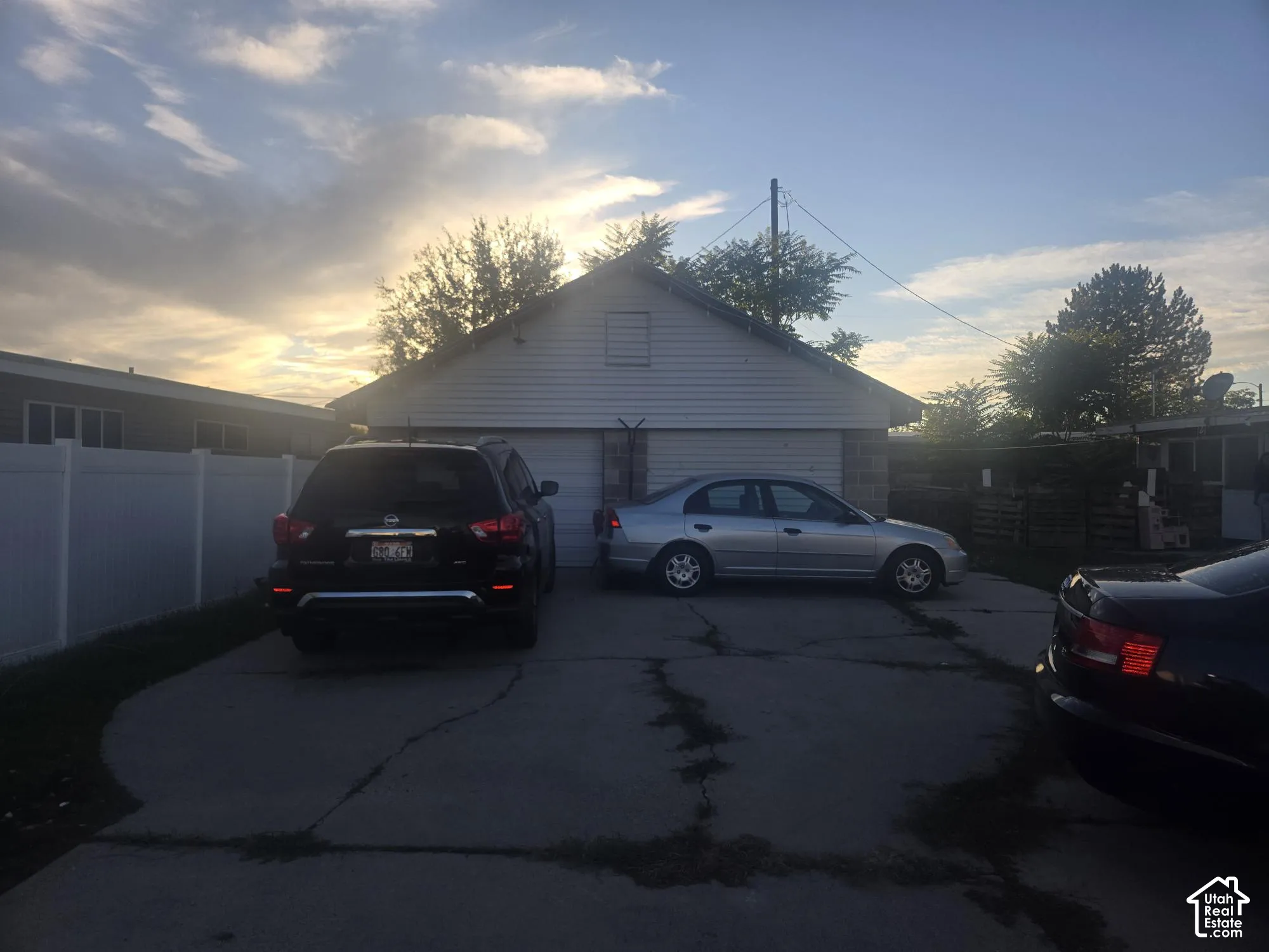 Detached two-car garage featuring horizontal siding and a concrete driveway