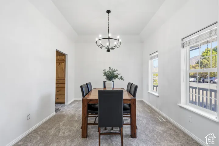 Tray ceiling, multi-light metal chandelier, and double-hung windows