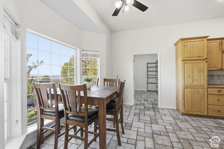 Vaulted ceilings, large bay windows, natural-finish cabinetry, and ceramic tile flooring