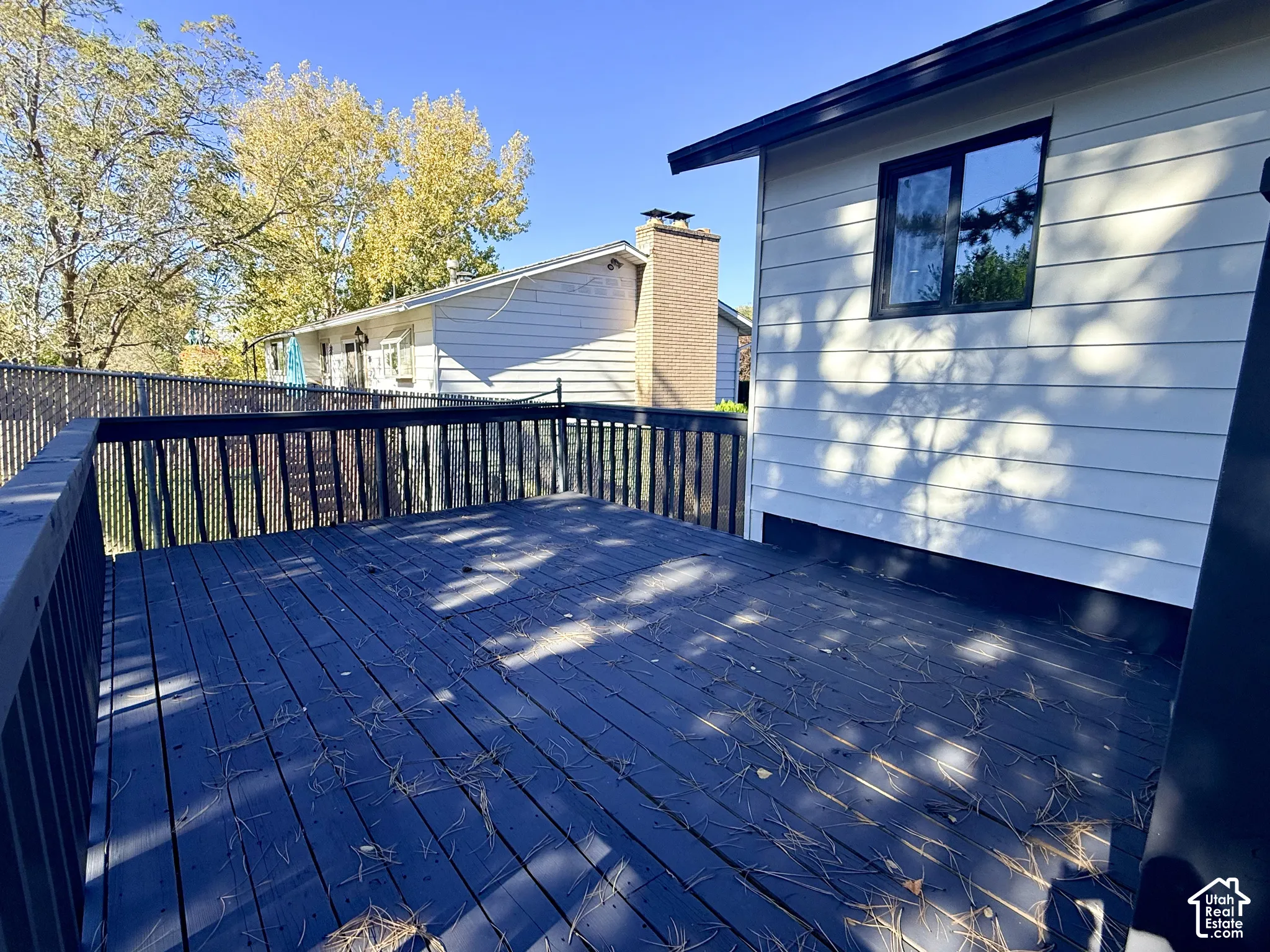 Raised exterior deck featuring dark-finish wood decking, perimeter railings, and horizontal lap siding