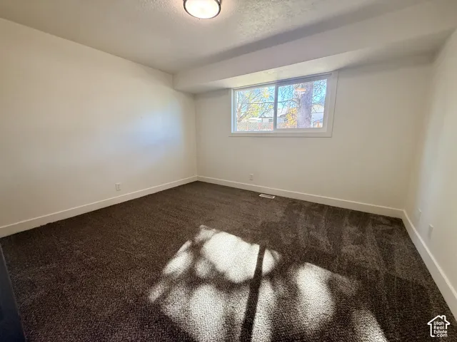 Neutral-toned carpeting, crisp white walls, and a recessed ceiling light fixture