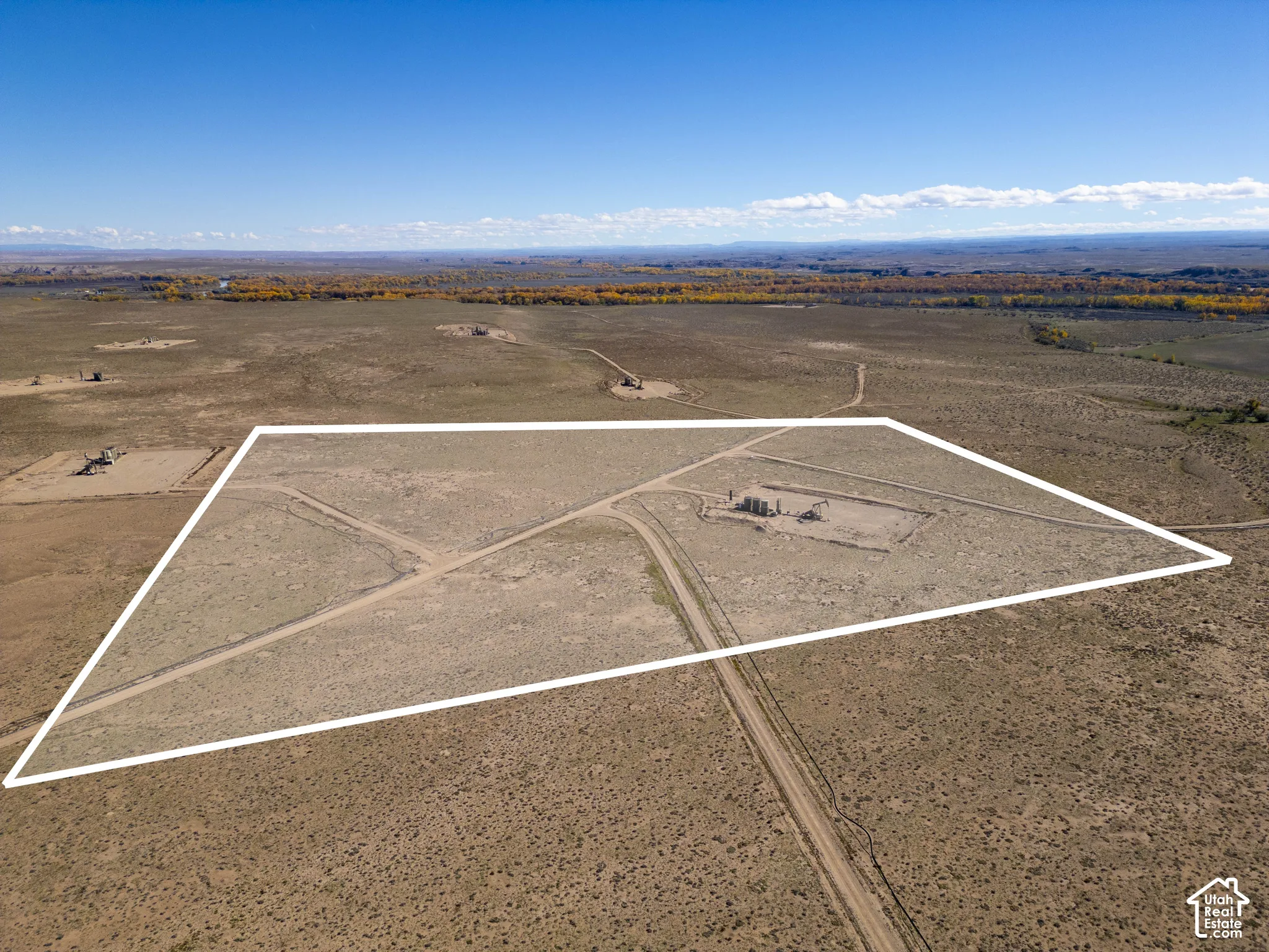 Expansive acreage featuring dirt access roads and open desert terrain