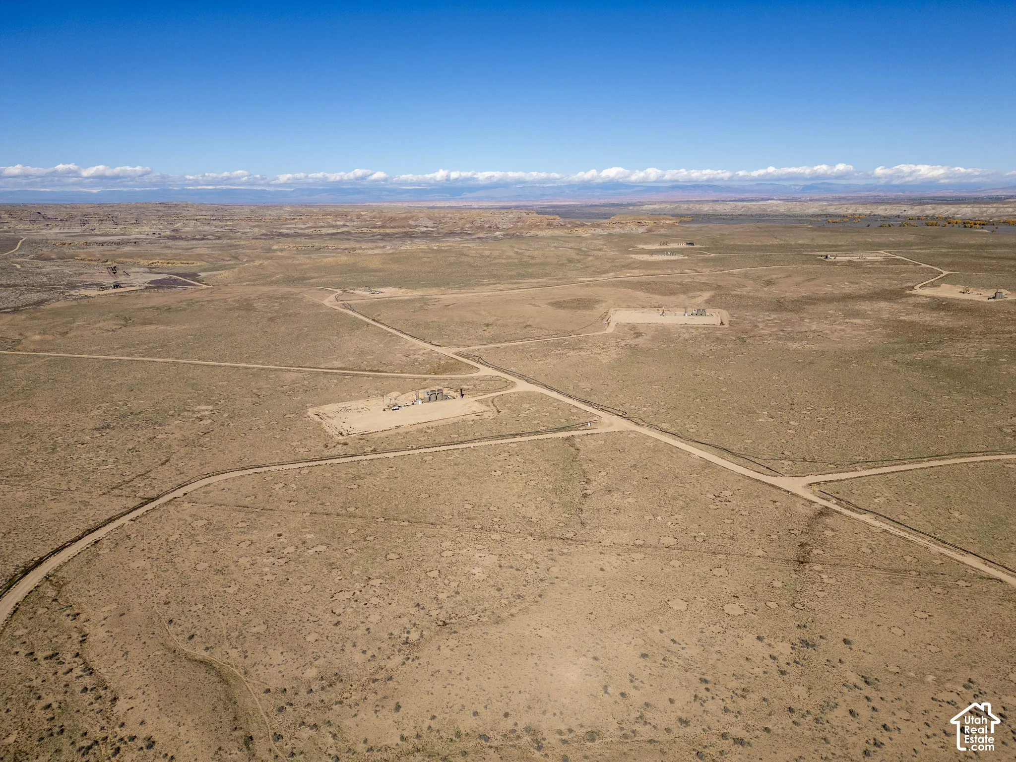 Expansive rural acreage featuring desert terrain, accessible dirt roads, and distant mountain backdrops