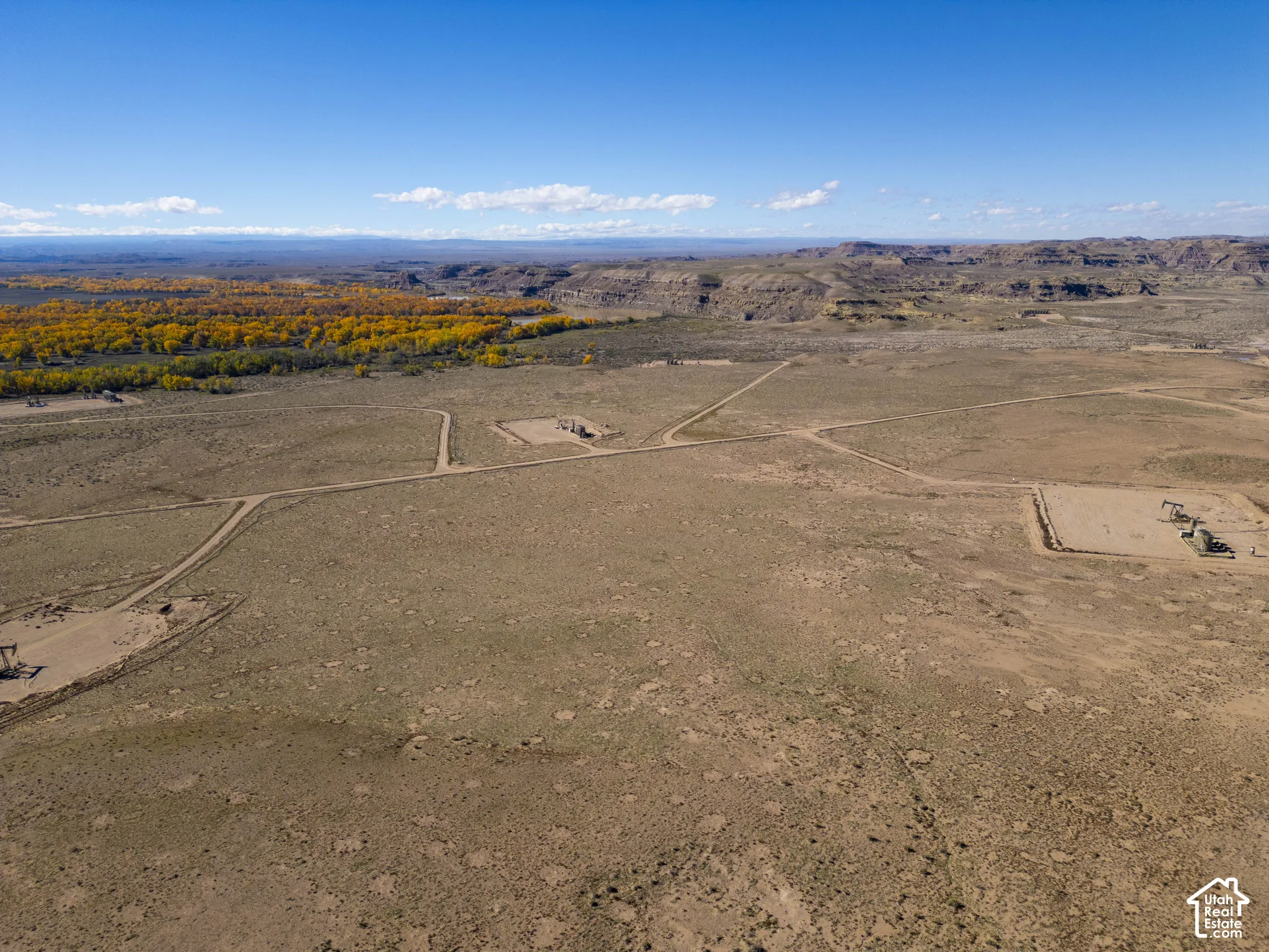 Expansive desert acreage featuring natural terrain, dirt-surface access roads, and mountain topography