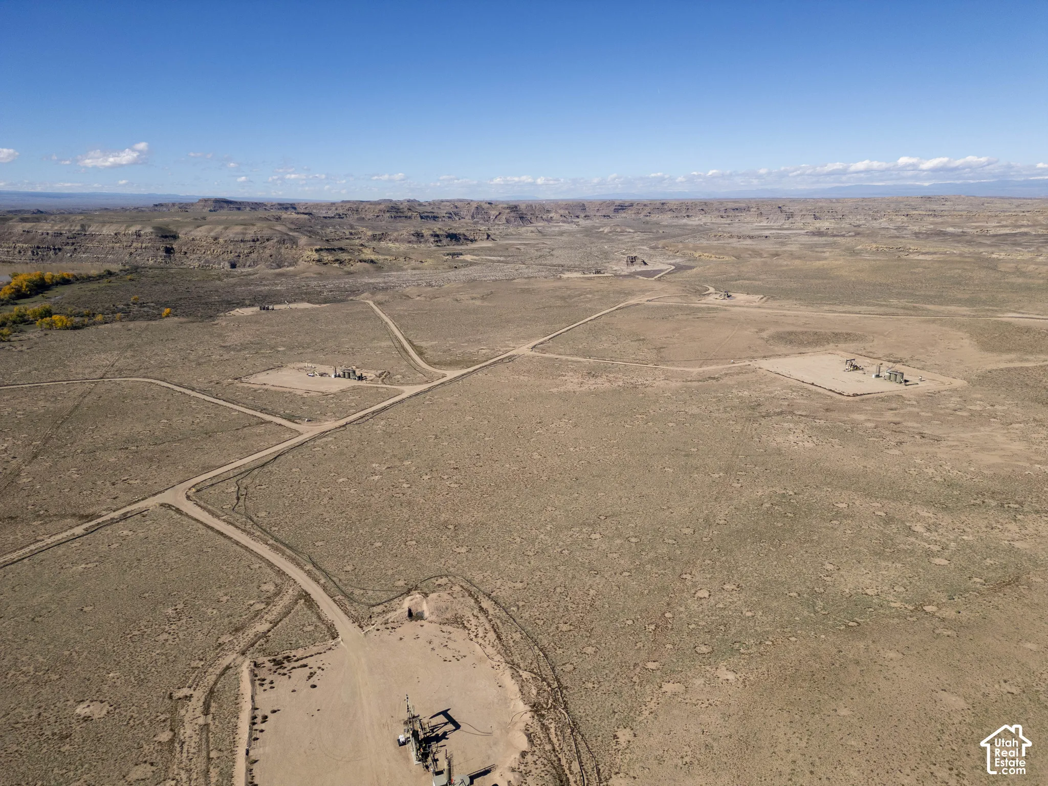 Expansive desert acreage featuring natural rock formations and established dirt access roads