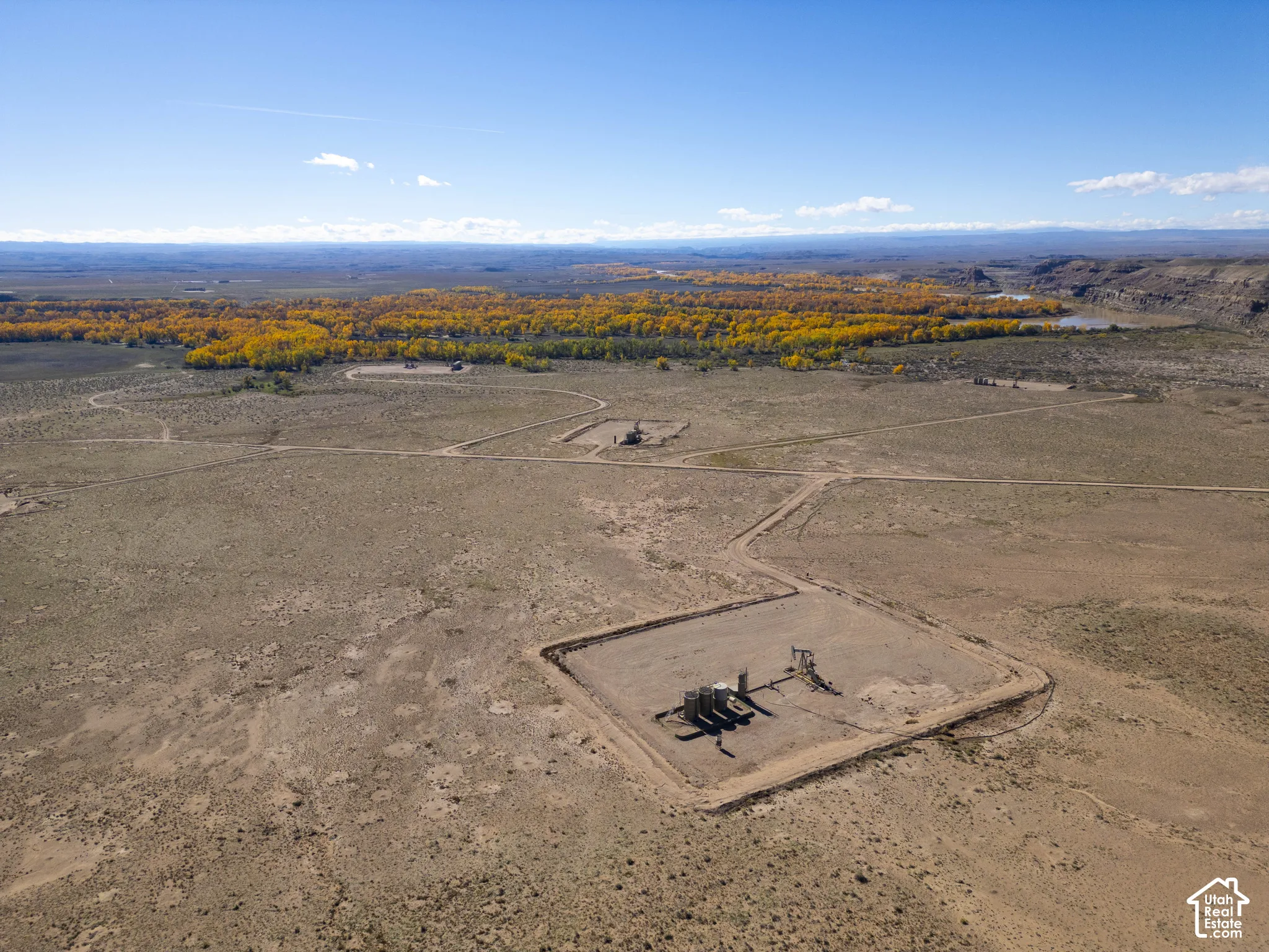 Expansive acreage featuring rugged desert terrain, natural riparian vegetation, and established dirt access roads
