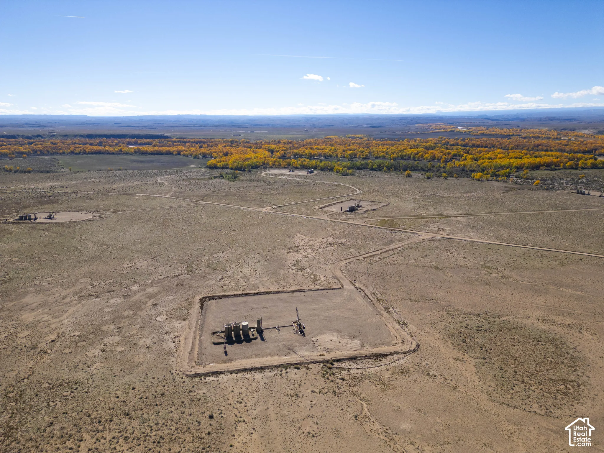 Expansive desert acreage featuring natural terrain, integrated industrial utility infrastructure, and clear horizon lines
