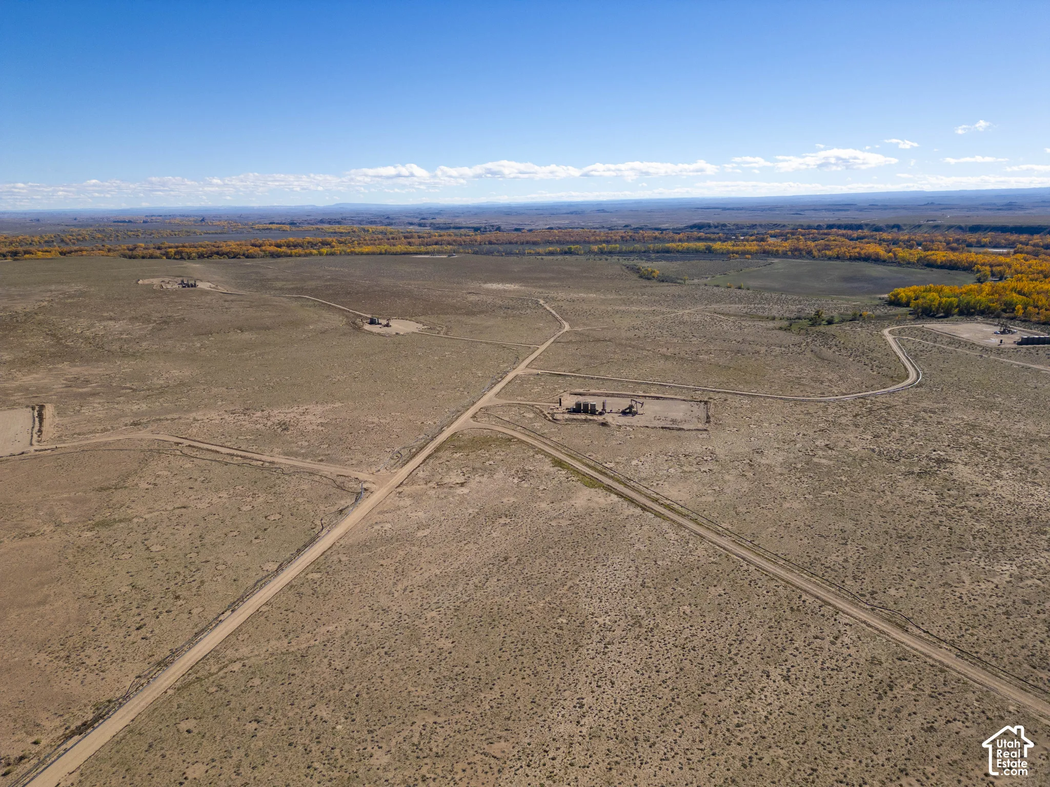 Expansive undeveloped acreage featuring dirt access roads, native high-desert vegetation, and natural foliage