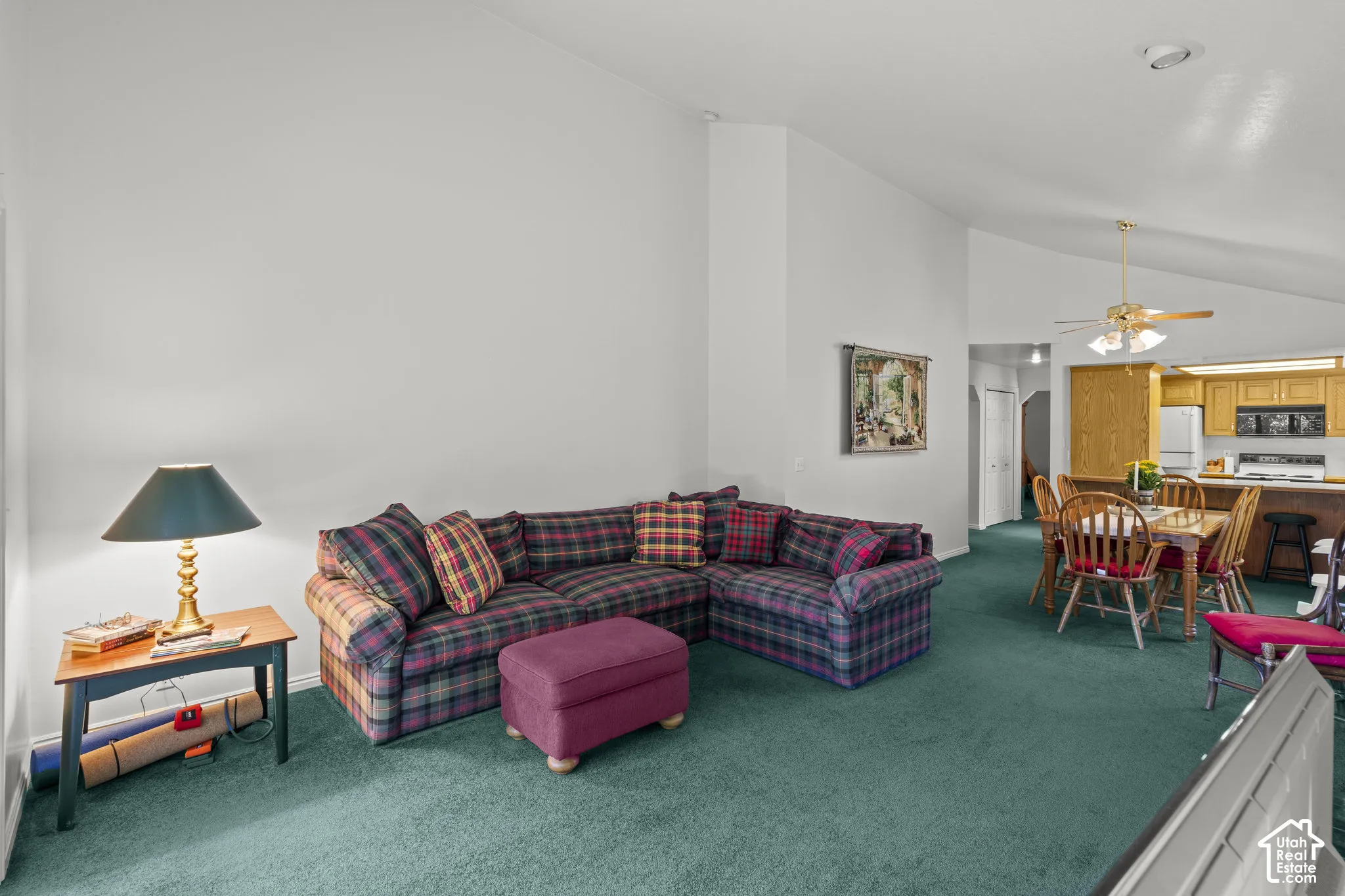 Vaulted ceilings, carpeting, and multi-bulb ceiling fan fixture