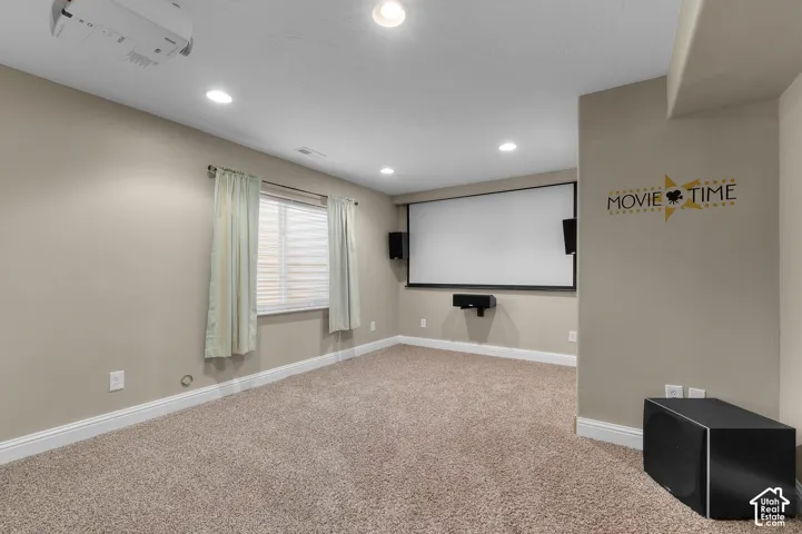 Recessed ceiling lighting, wall-mounted projection screen, integrated speaker system, and ceiling-mounted projector