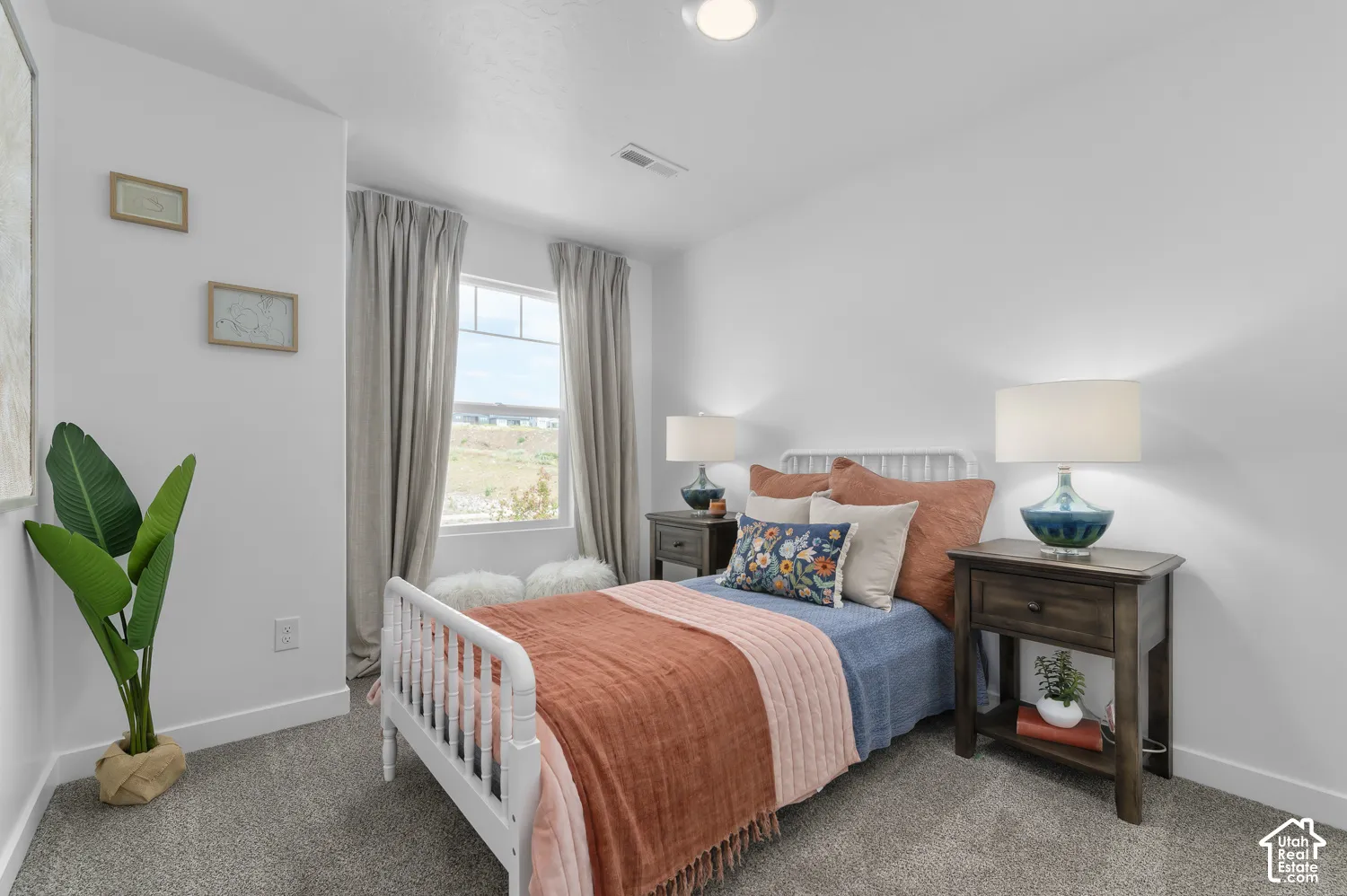 Neutral-toned carpet, recessed ceiling lighting, and a single-pane window featuring a horizontal muntin