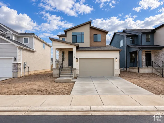 Modern multi-story exterior featuring a mix of stucco, stone veneer, and horizontal siding, a covered entryway with a concrete staircase, and a double-car garage