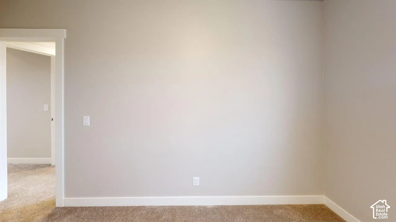 Neutral-toned walls, high-profile door casing, and wall-to-wall carpeting