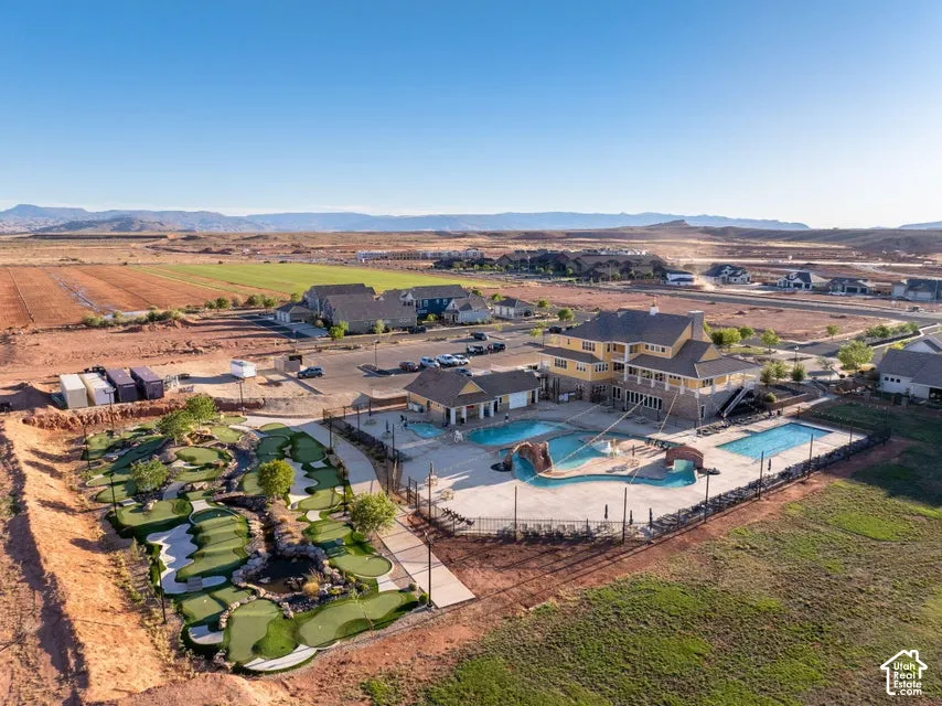 Community recreation area featuring multiple swimming pools, a water slide, a miniature golf course, and a clubhouse