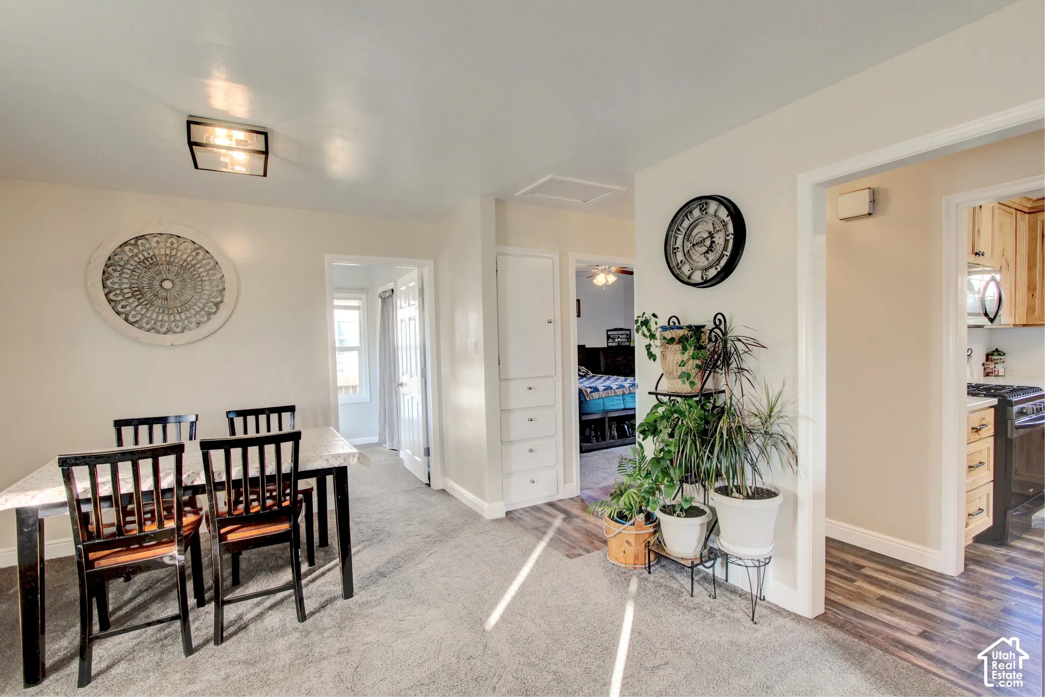 Built-in floor-to-ceiling cabinetry, square flush-mount ceiling lighting, and mixed flooring featuring carpet and wood-finish planks