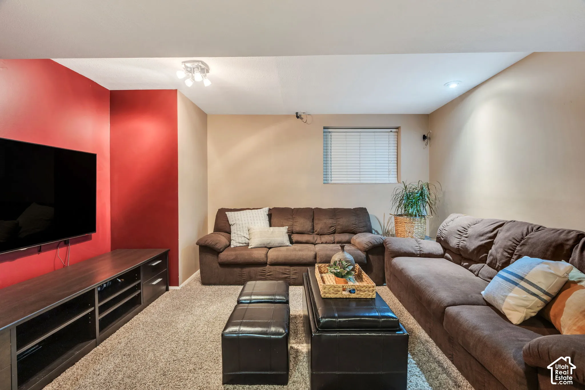 Interior space featuring wall-to-wall carpeting, recessed ceiling lighting, and a single window with blinds