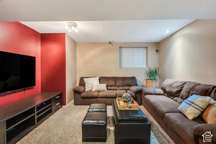 Interior space featuring wall-to-wall carpeting, recessed ceiling lighting, and a single window with blinds