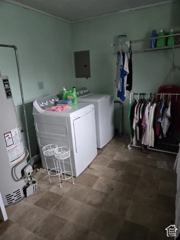 Utility space featuring square-tile flooring and an integrated water heater