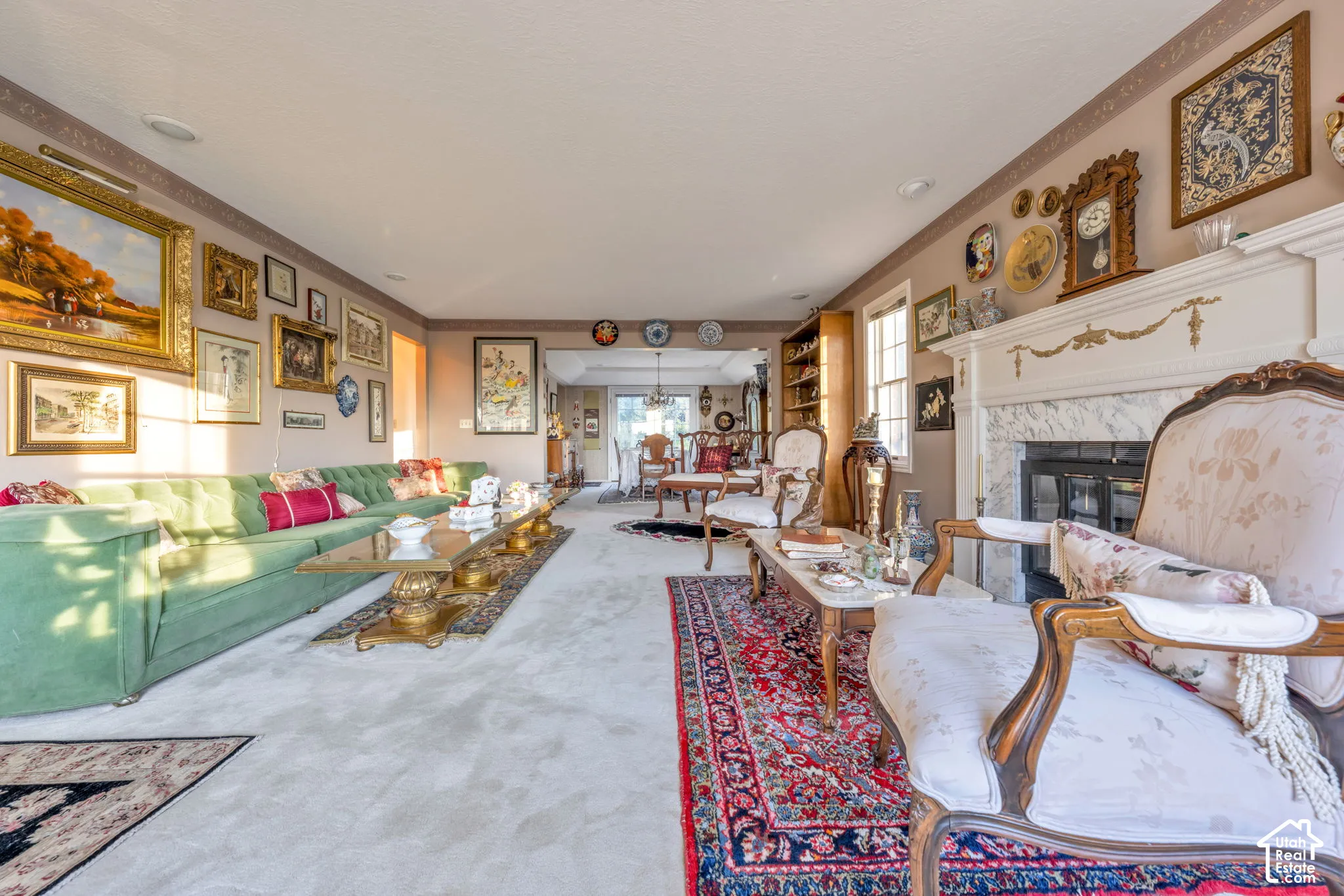 Formal living area featuring a fireplace with a decorative mantel and stone surround