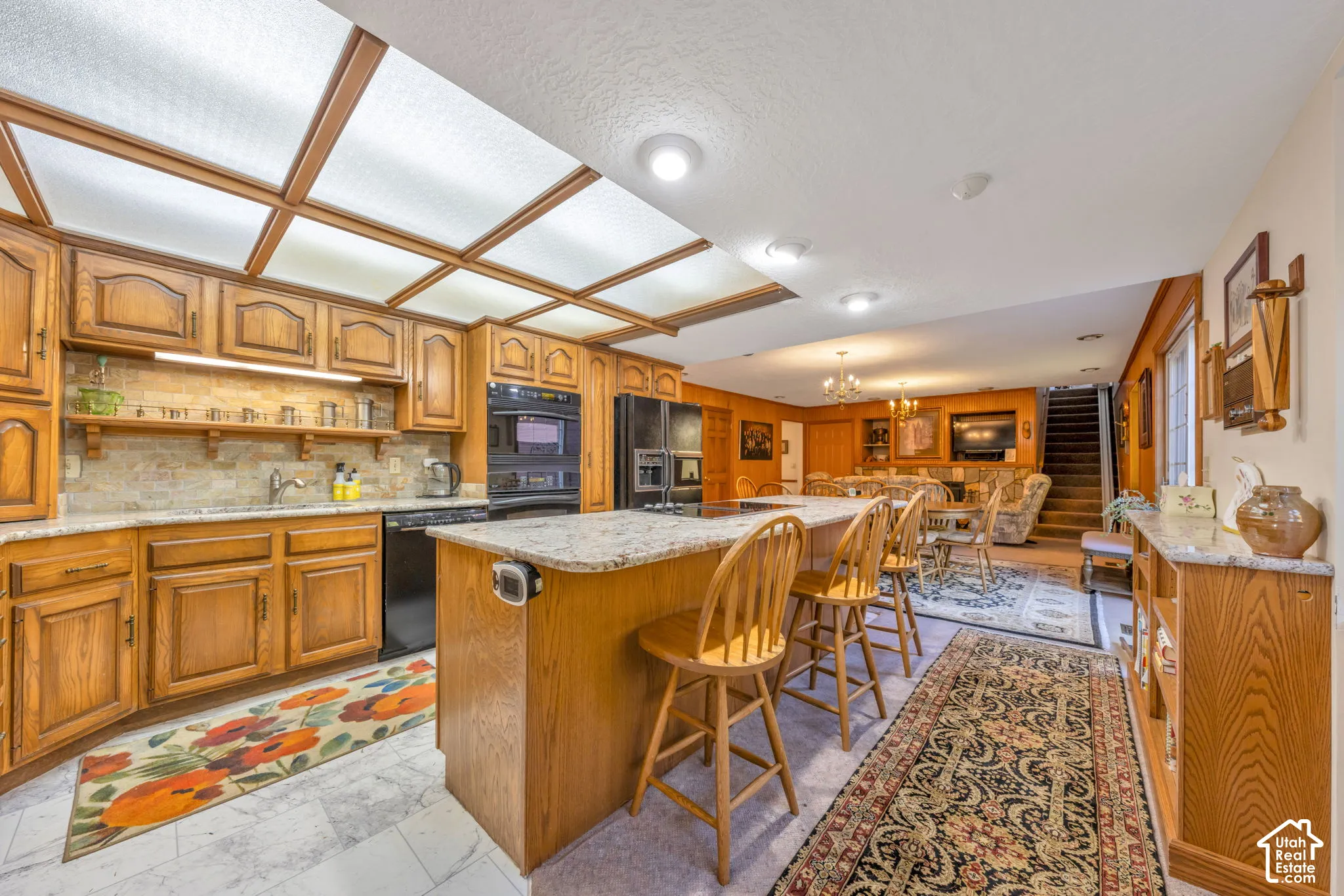 Large kitchen area completely open to family room creating a large great-room with a stone fireplace.