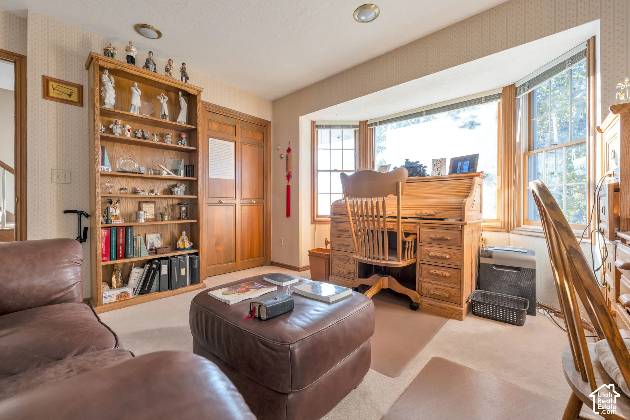 Comfortable size office with closet, could be a bedroom, with natural light through the bay window