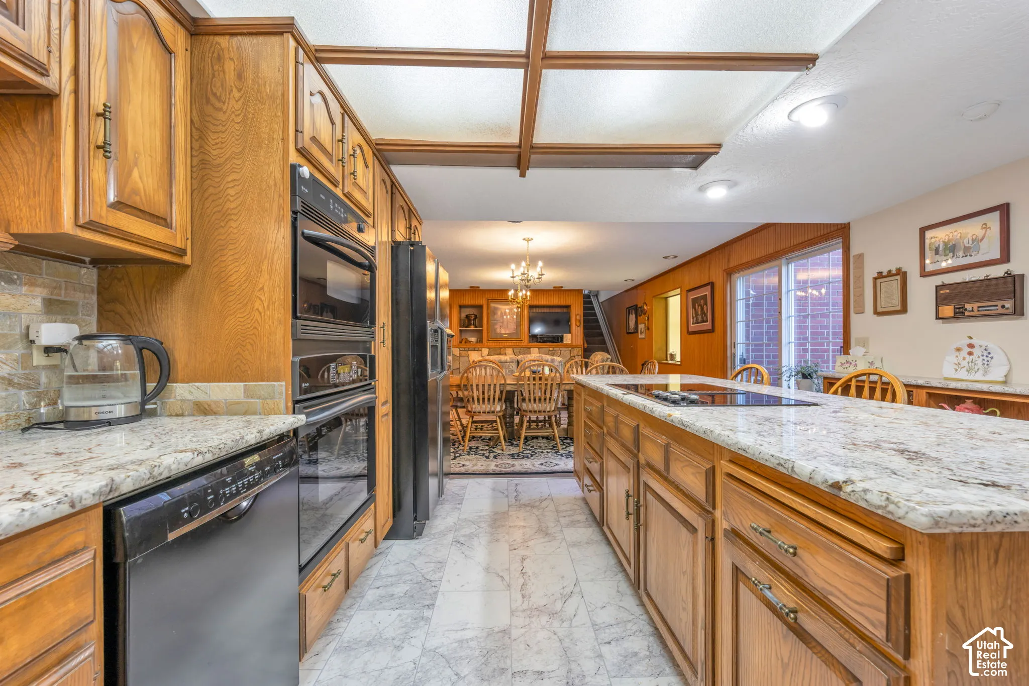Large kitchen area completely open to family room creating a large great-room with a stone fireplace.