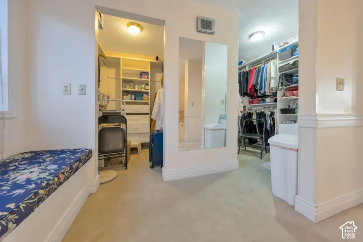 Walk-in closets featuring built-in shelving, integrated dresser drawers, full-length mirror, and built-in bench seating