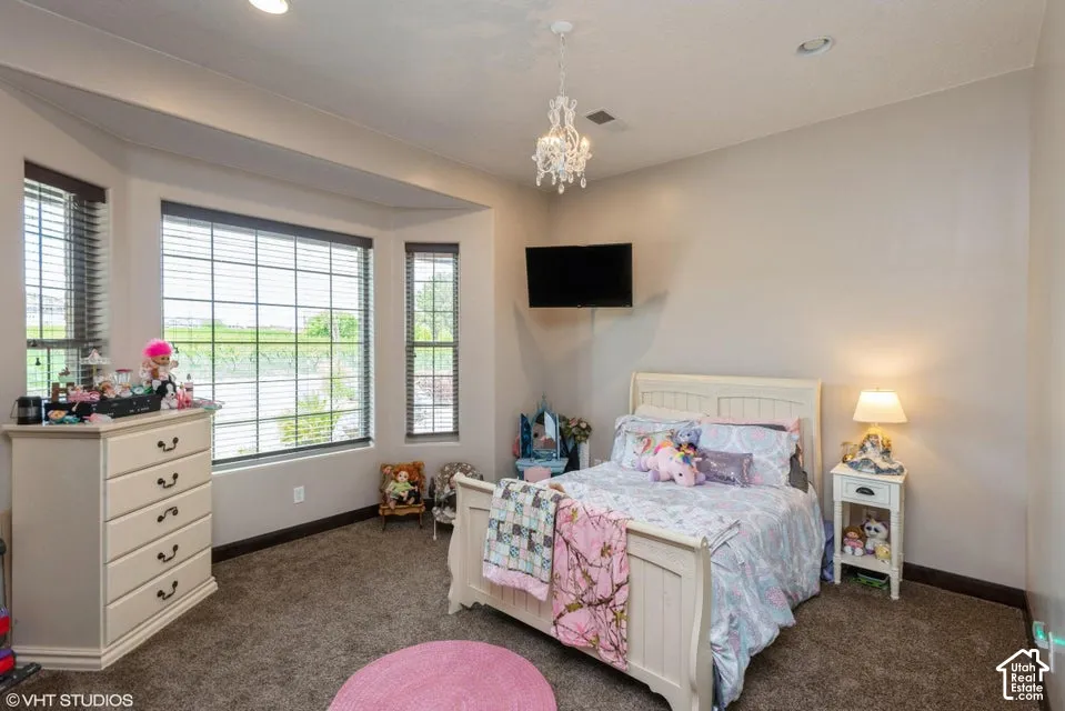 Bay window featuring multiple panels, recessed ceiling lighting, decorative chandelier, and carpeted flooring