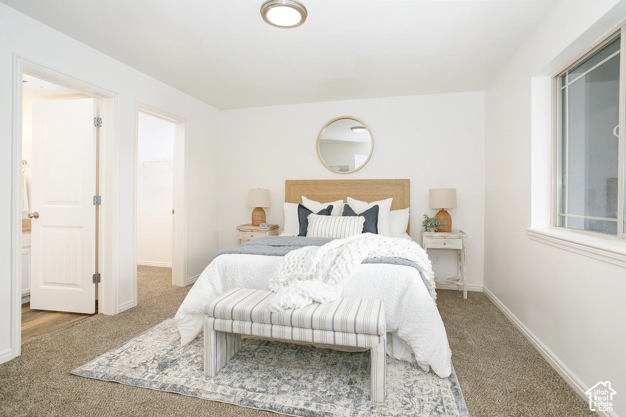 Neutral-toned wall-to-wall carpeting, flush-mount lighting, and dual doorways