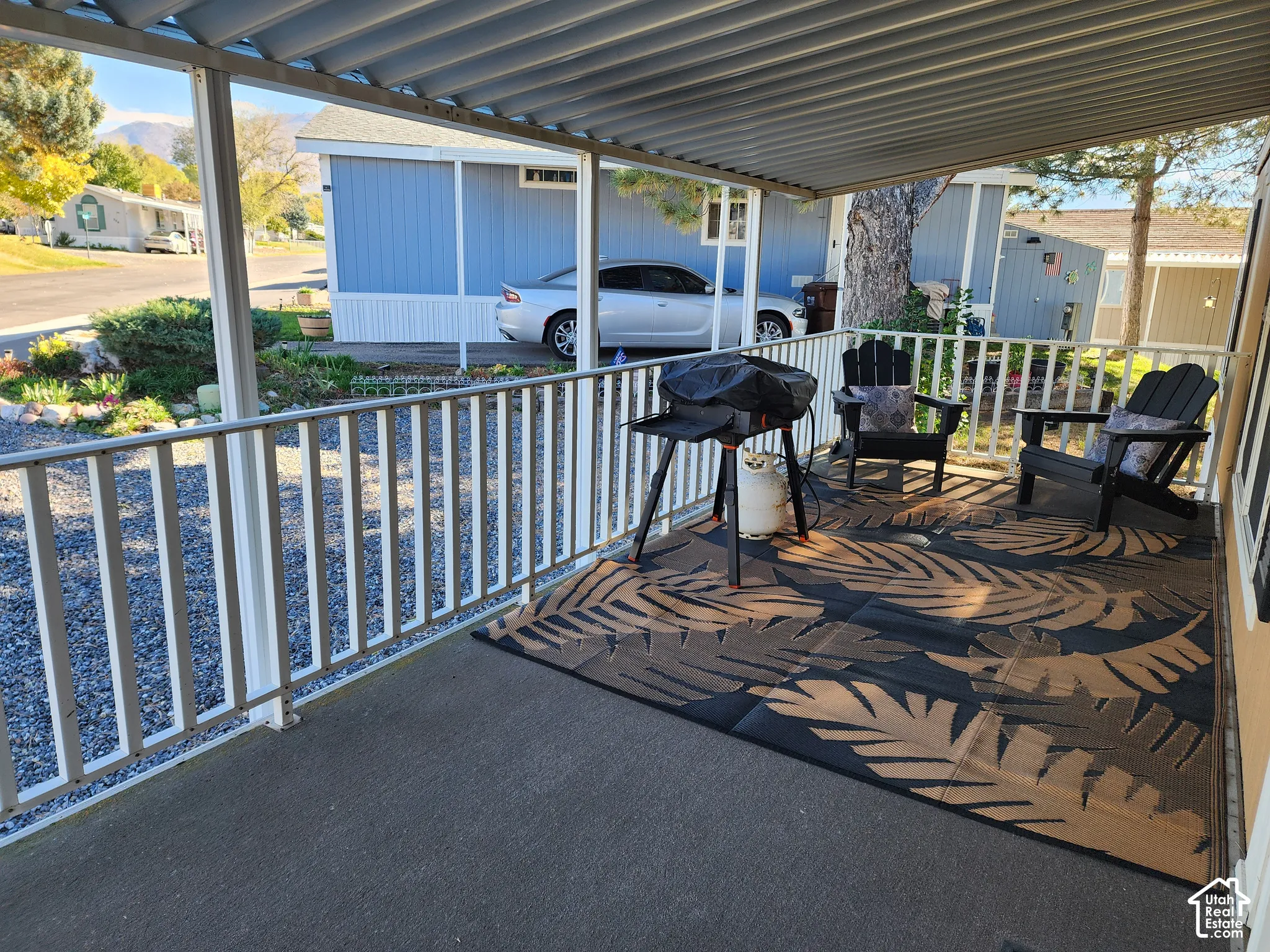 Covered porch featuring a metal roof and metal railing