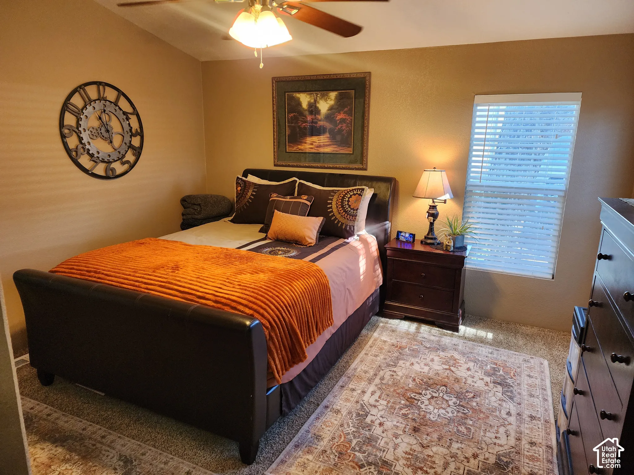 Room featuring carpeted flooring, window with horizontal blinds, and a ceiling fan with light fixture