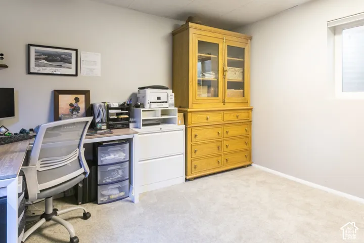 Neutral-toned interior space featuring light-colored wall-to-wall carpeting and a recessed window