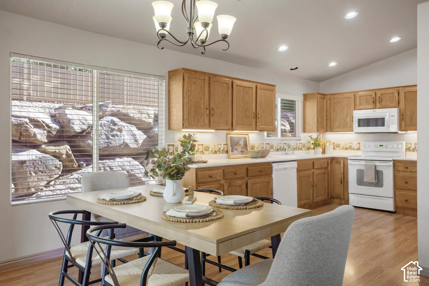 Kitchen featuring wood cabinetry, recessed lighting, wood-finish flooring, and white appliances including an over-the-range microwave