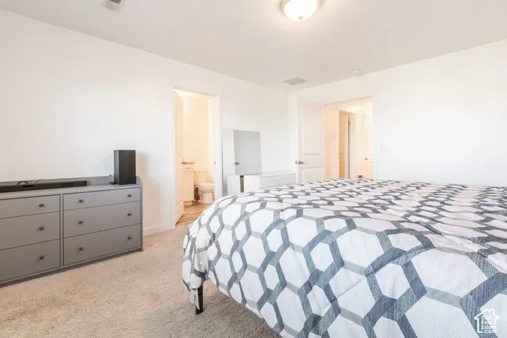 Neutral-toned wall-to-wall carpeting, flush-mount ceiling lighting, and solid-core interior doors