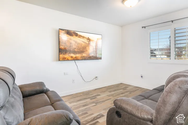 Wood-finish flooring, white walls, and interior plantation shutters