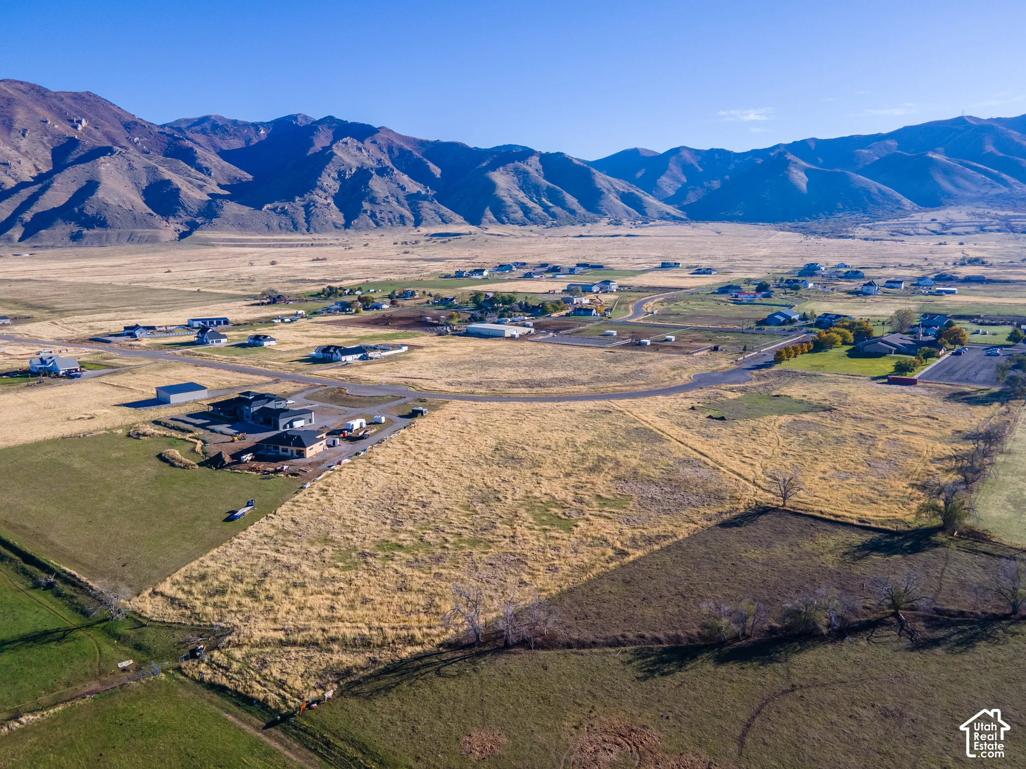 Expansive parcel of land featuring open acreage and a prominent mountain range backdrop