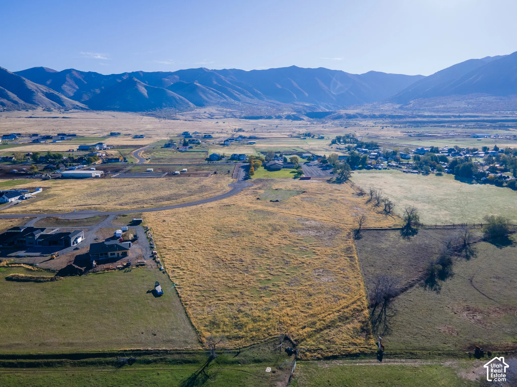 Expansive land parcel featuring prominent mountain terrain, open acreage, and paved road access