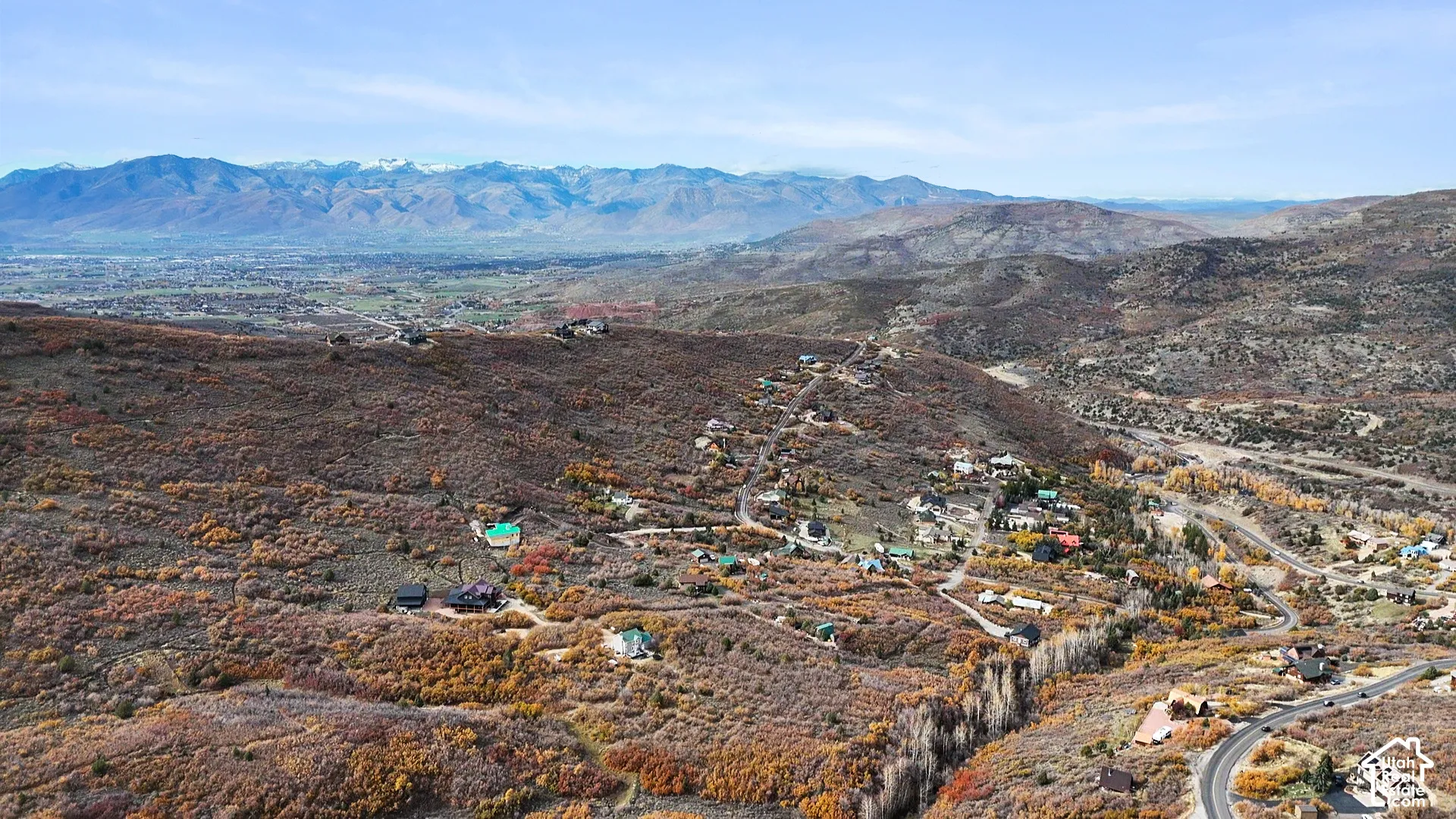 Elevated aerial perspective featuring expansive mountain range surroundings and hilly topography with natural shrubland vegetation
