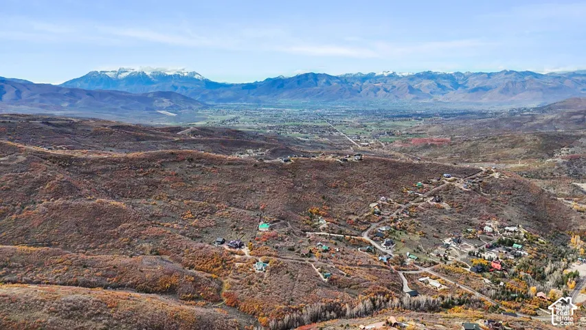 Aerial perspective featuring expansive mountain topography, elevated ridgeline positioning, and vast valley floor exposure